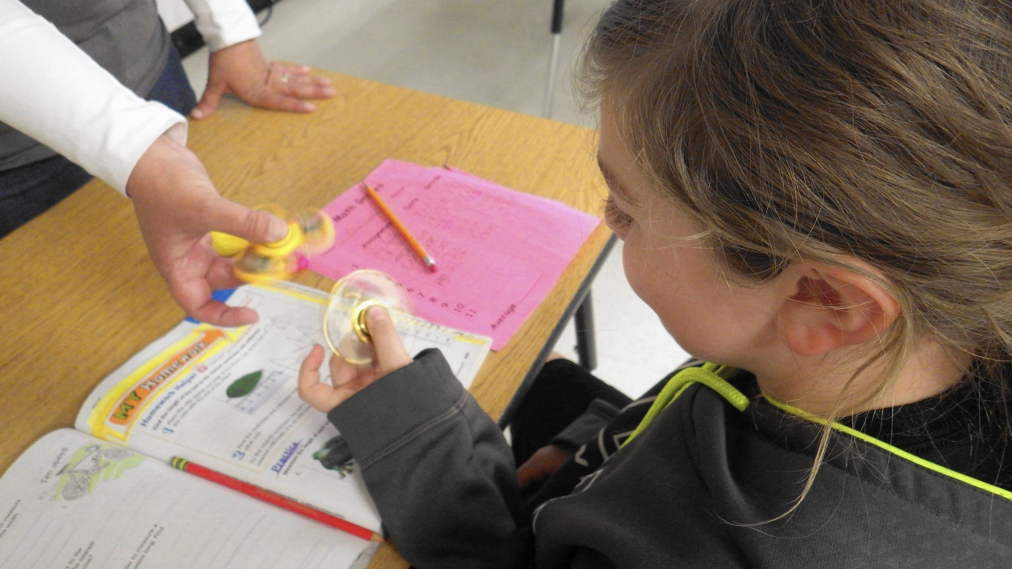 student playing with fidget spinner