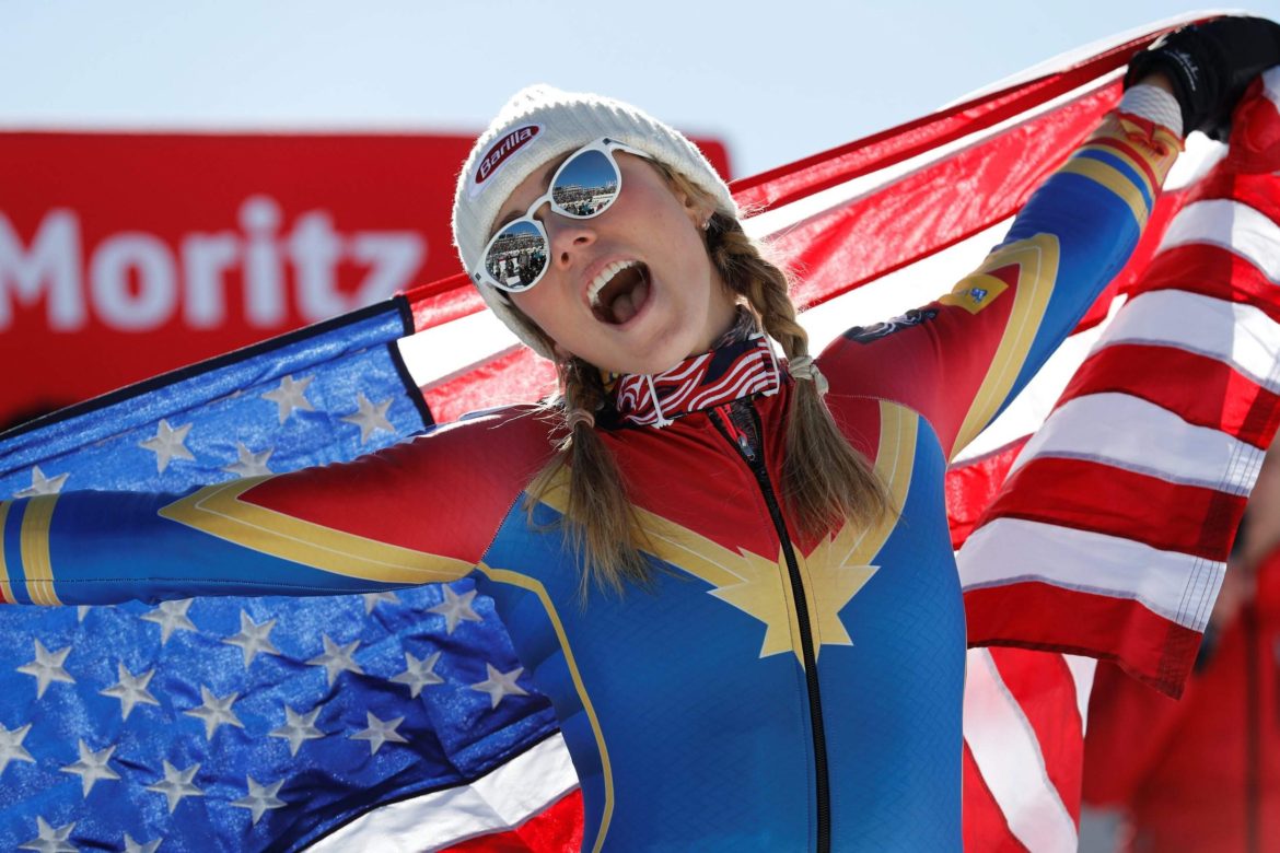 Mikaela Shiffrin dressed as Captain Marvel, holding American flag