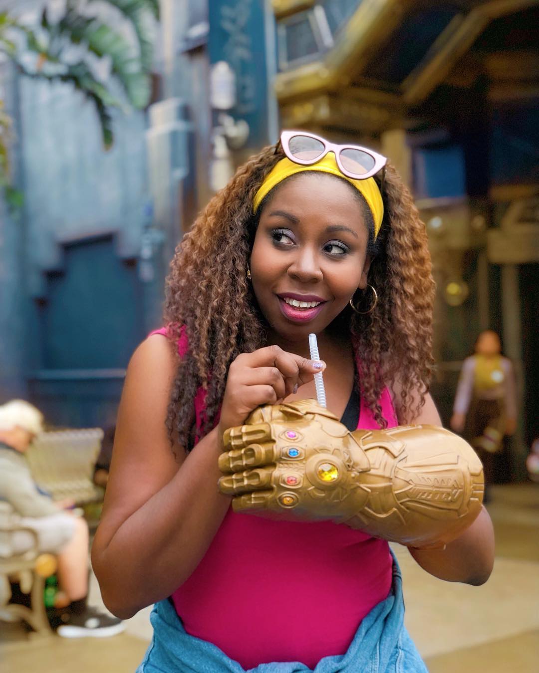 woman drinking from infinity gauntlet cup in disneyland