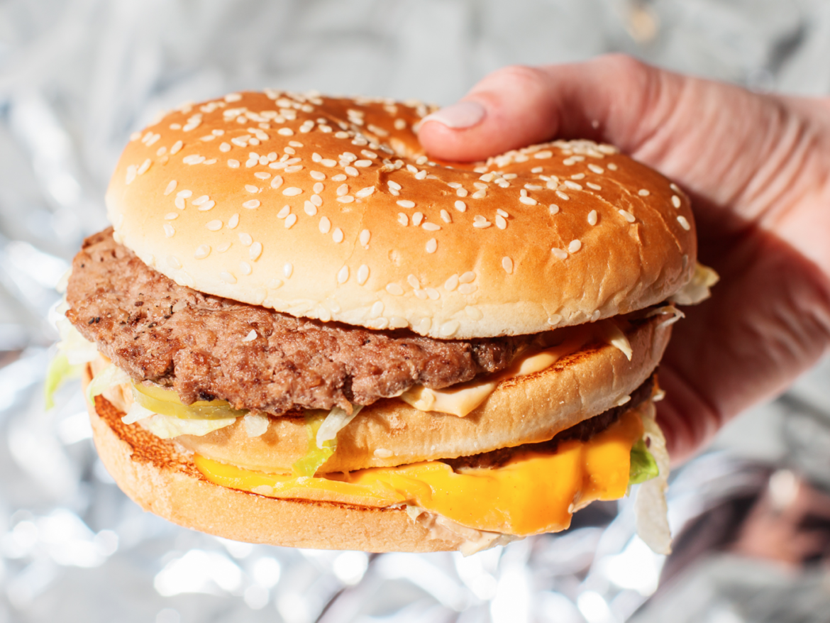 Man holding big mac to camera