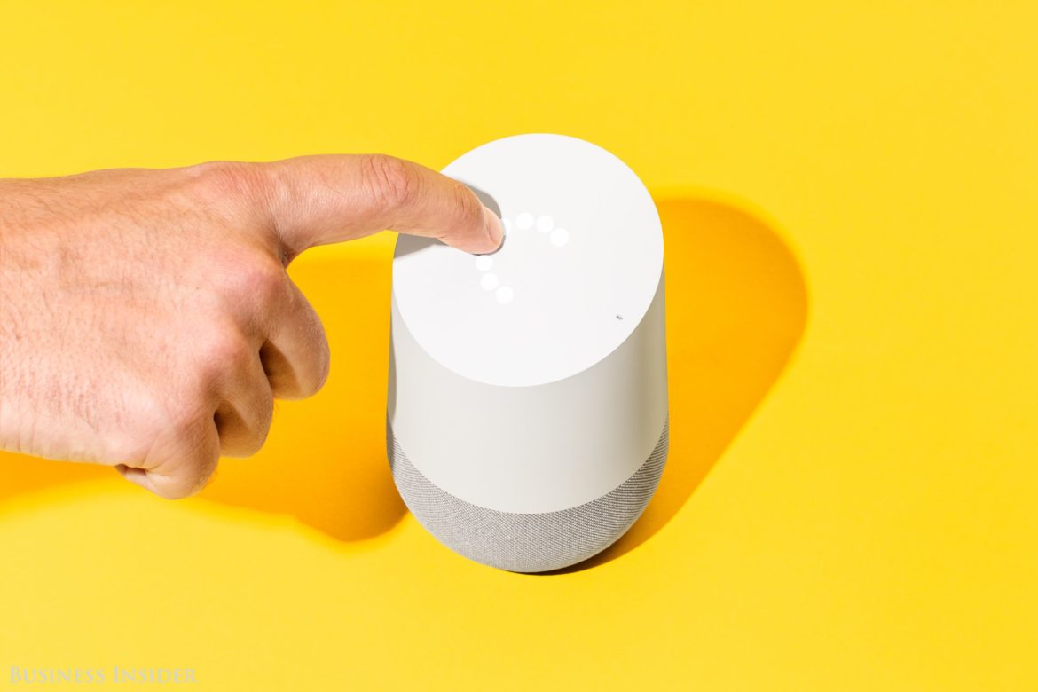 Hand touching top of Google Home